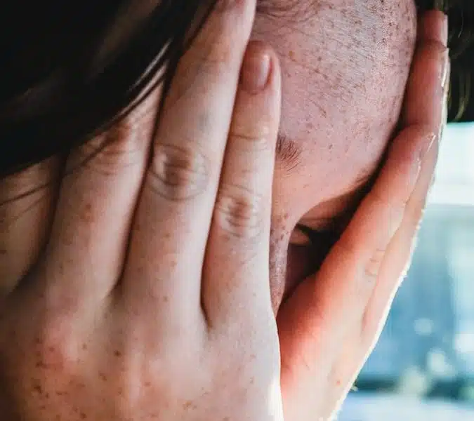 woman covering her face